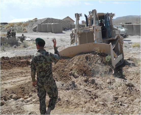 Afghan National Army soldier guides bulldozer